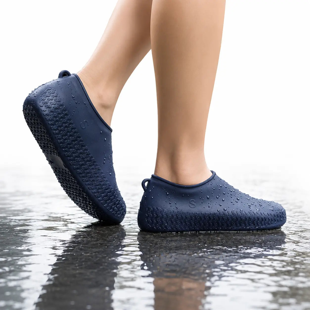 Person Wearing Non-Slip Silicone Waterproof Shoe Covers While Walking on Wet Surface
